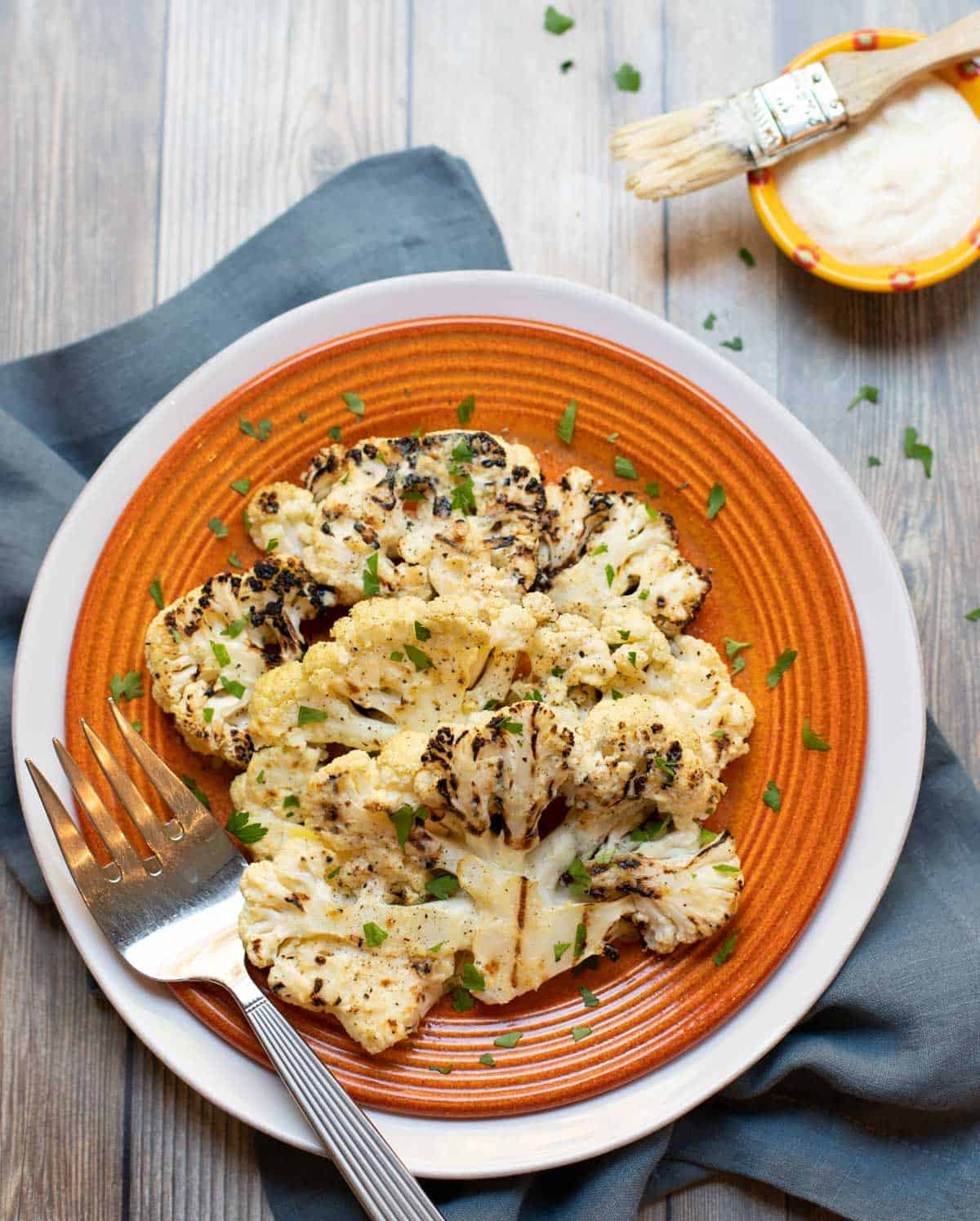 Grilled slices of cauliflower with a tangy Parmesan sauce