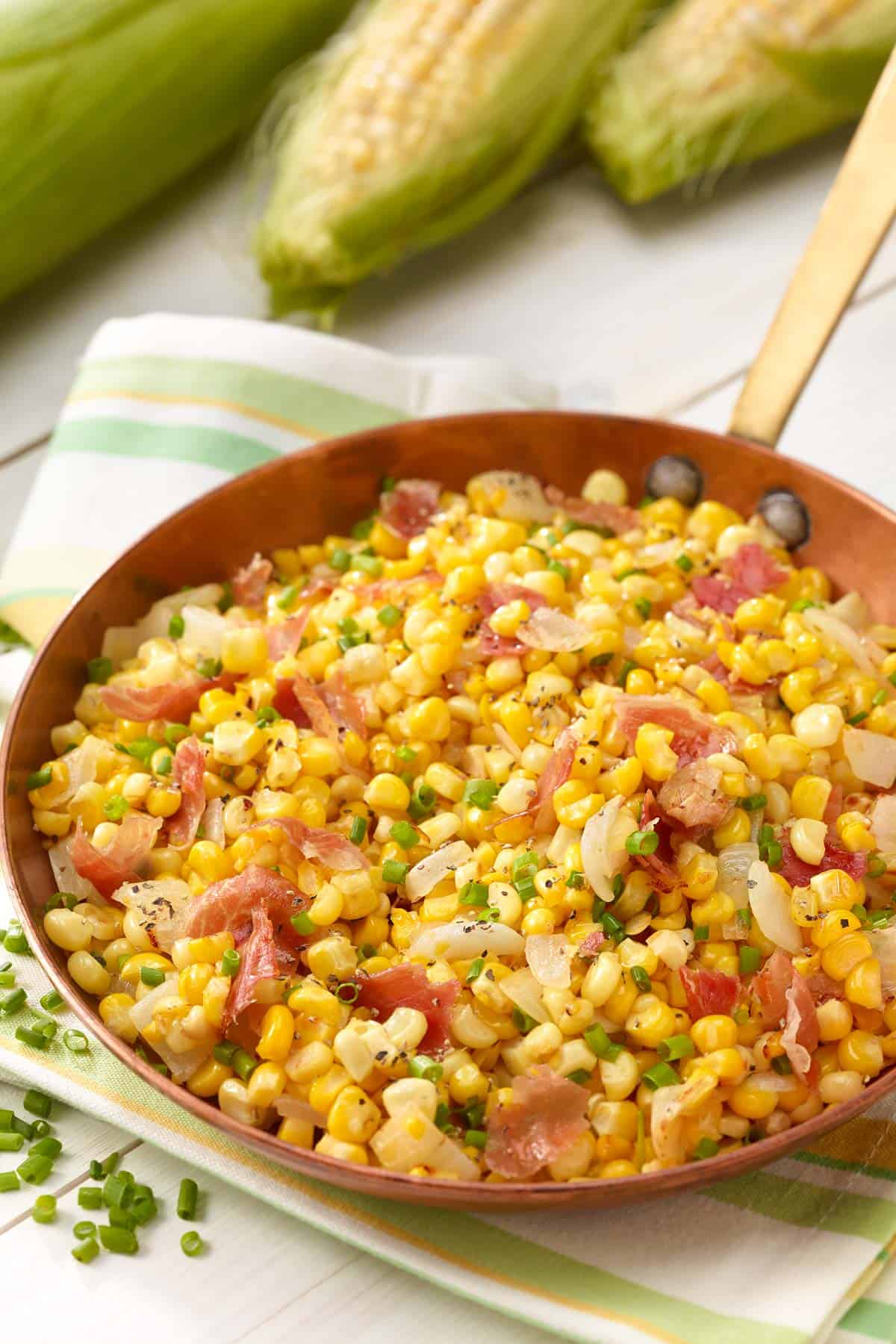 Copper skillet filled with Corn and Prosciutto Salad