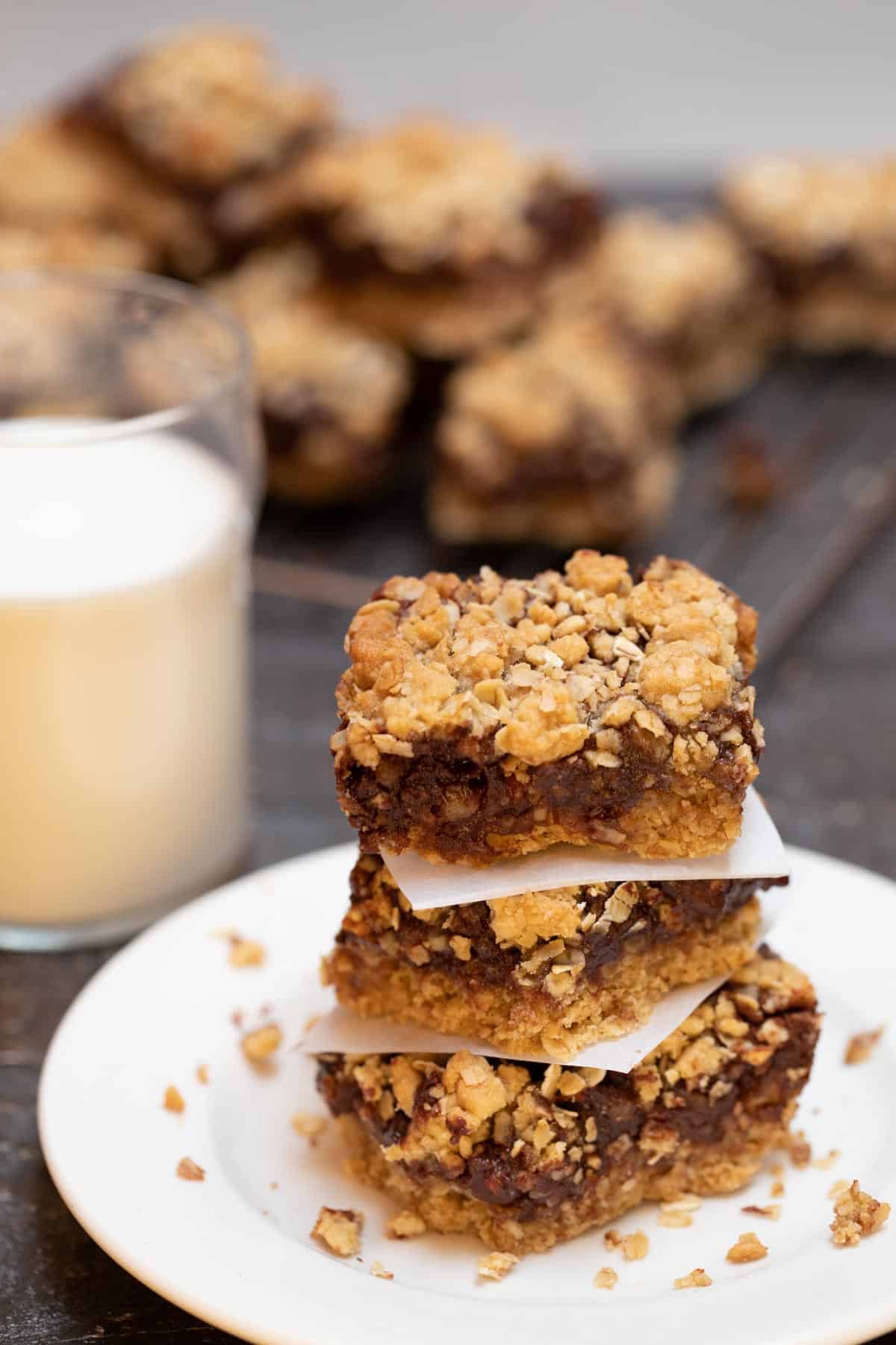 Stack of 3 Layered Oatmeal Chocolate Bars with a glass of milk