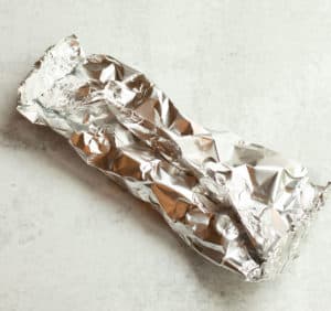 foil packet with potatoes inside, ready for grilling
