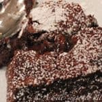 close up of a heart shaped mini chocolate cake, cut into on top to show melty filling.