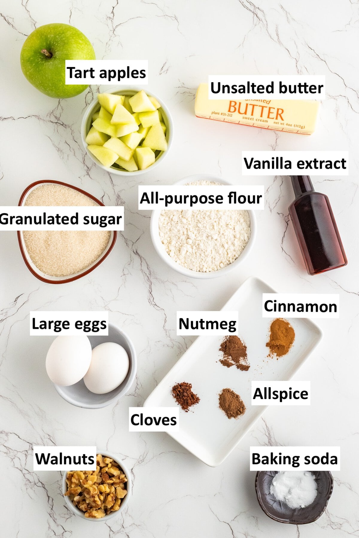 Ingredients to make this apple bundt cake recipe on the table in dishes.