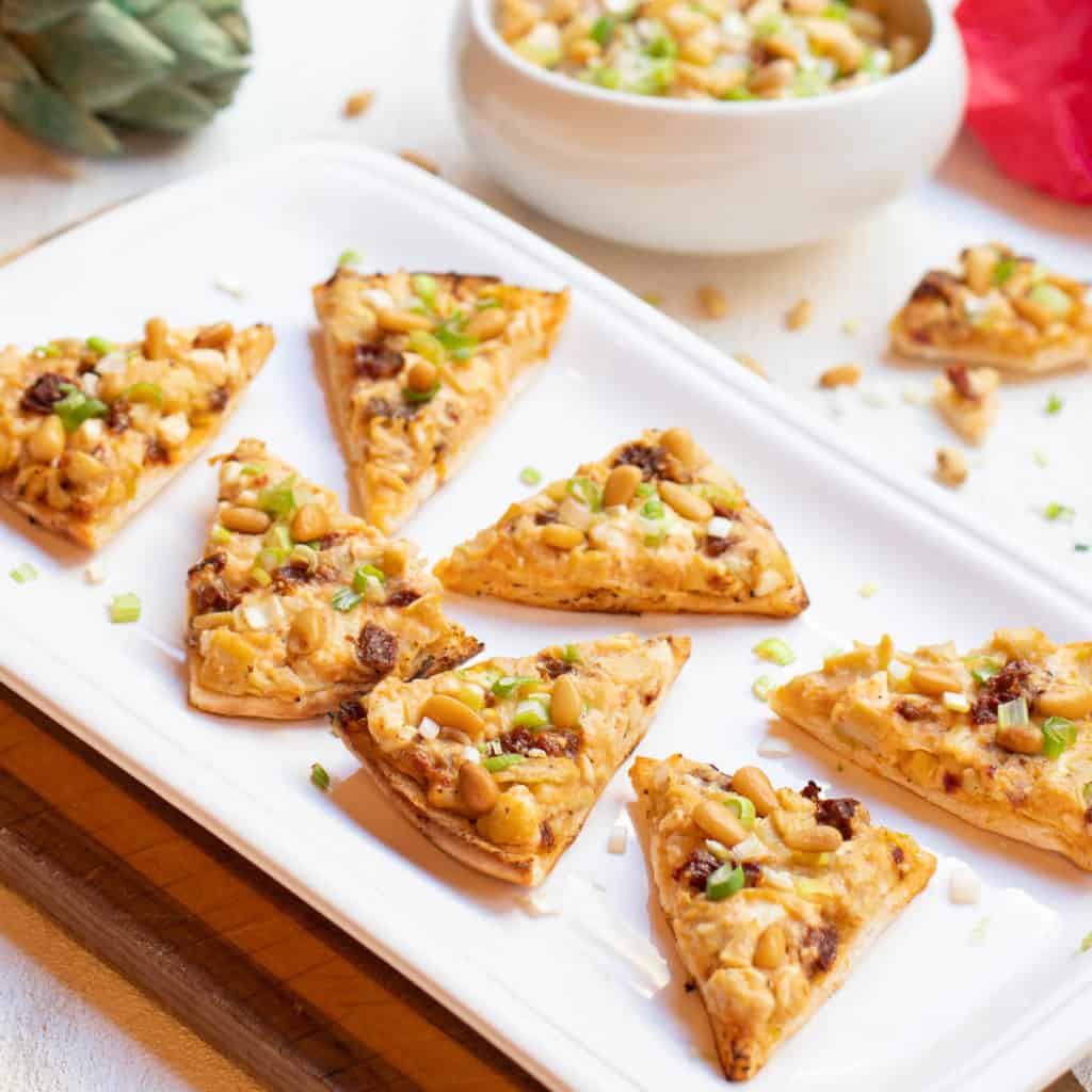 artichoke, sundried tomato and feta triangles on platter