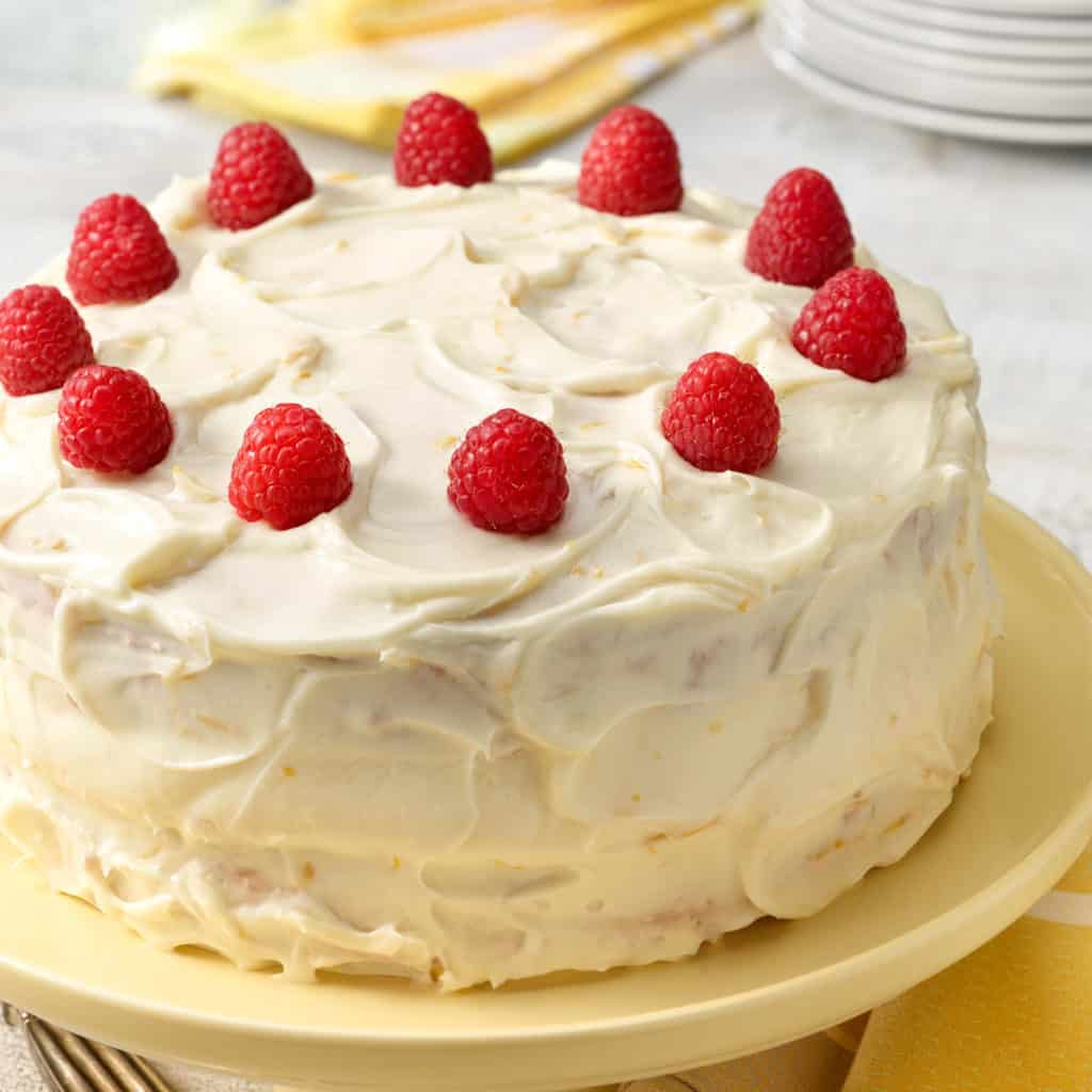close up of Moist Banana Cake decorated with raspberries