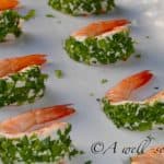 Serving platter holding 6 stuffed shrimp.