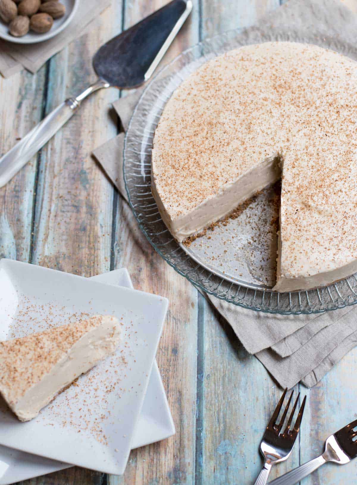 Frozen Brandy Alexander PIe on a glass plate, with a slice taken out. Slice is in bottom left of photo