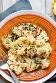 Grilled cauliflower slices with a tangy Parmesan cheese sauce