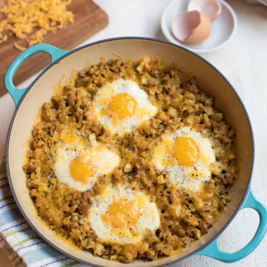 Blue baking dish with Cheesy Baked Eggs with Leftover Stuffing