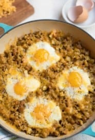 Blue baking dish with Cheesy Baked Eggs with Leftover Stuffing