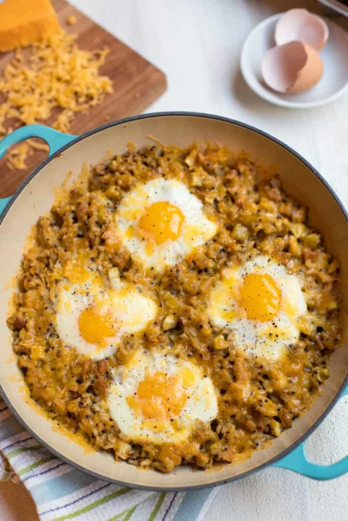 Blue baking dish with Cheesy Baked Eggs with Leftover Stuffing