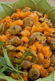 roasted chicken sausage and butternut squash in a green baking dish