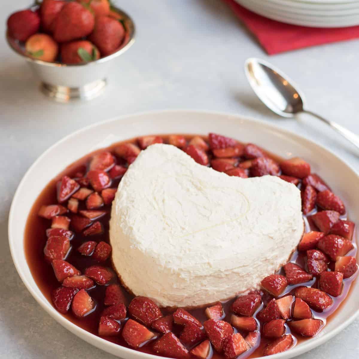 Large white platter filled with Coeur a la Creme and Strawberry Currant Sauce