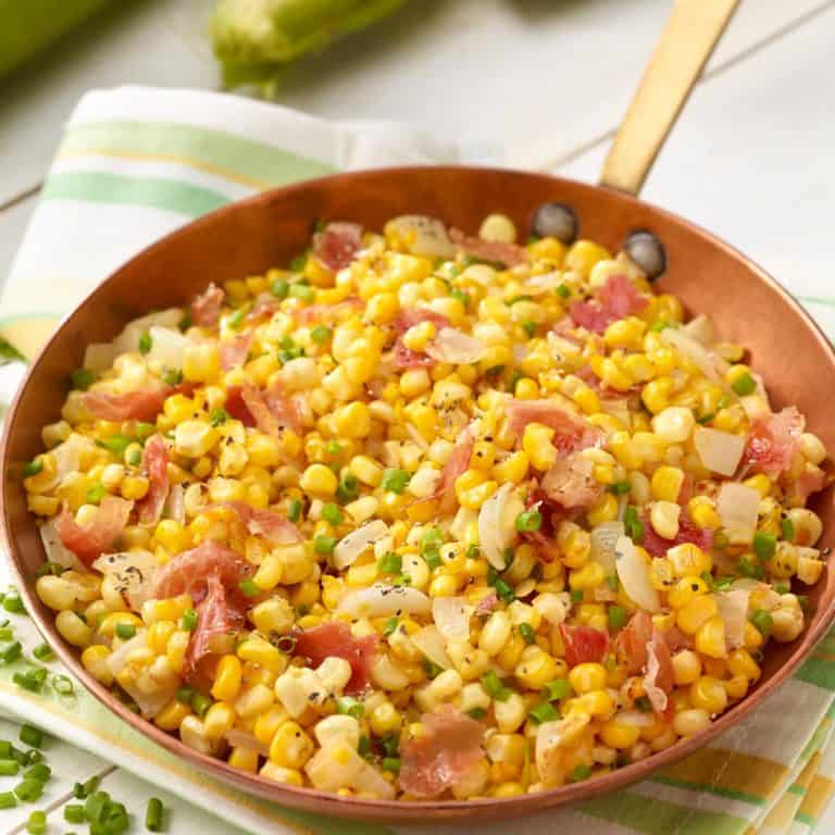 Copper skillet filled with Corn and Prosciutto Salad