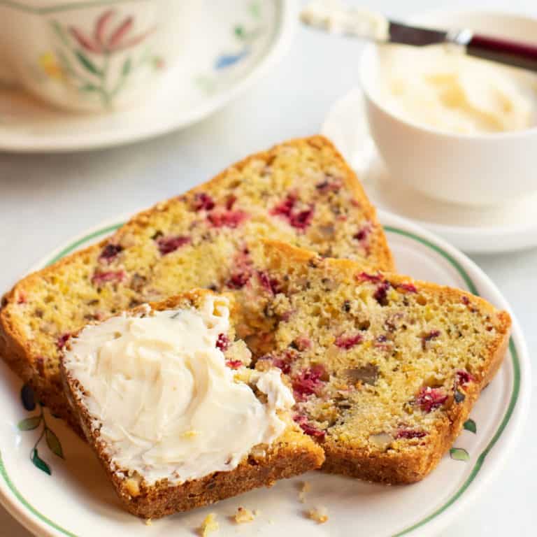 Two slices of Cranberry Nut Bread with butter