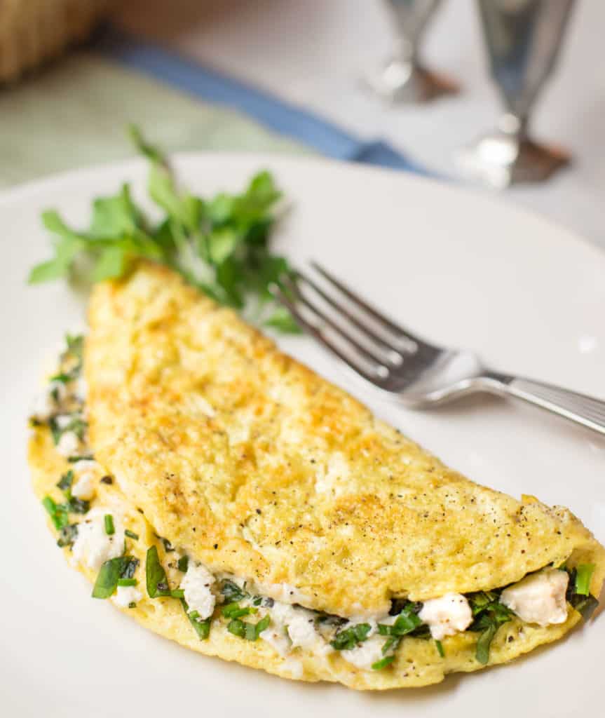 White plate with a Goat Cheese and Fresh Herb Omelet