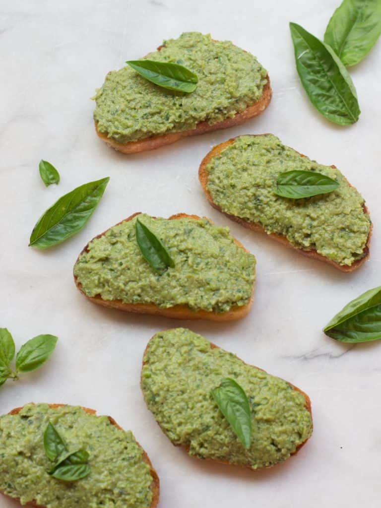 Slices of Green Pea, Basil and Mint Crostini on a slab of marble