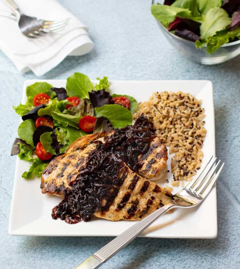 Grilled chicken breasts with caramelized red onion, quinoa and brown rice, and tossed salad