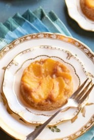Individual upside down peach cake on a dessert plate