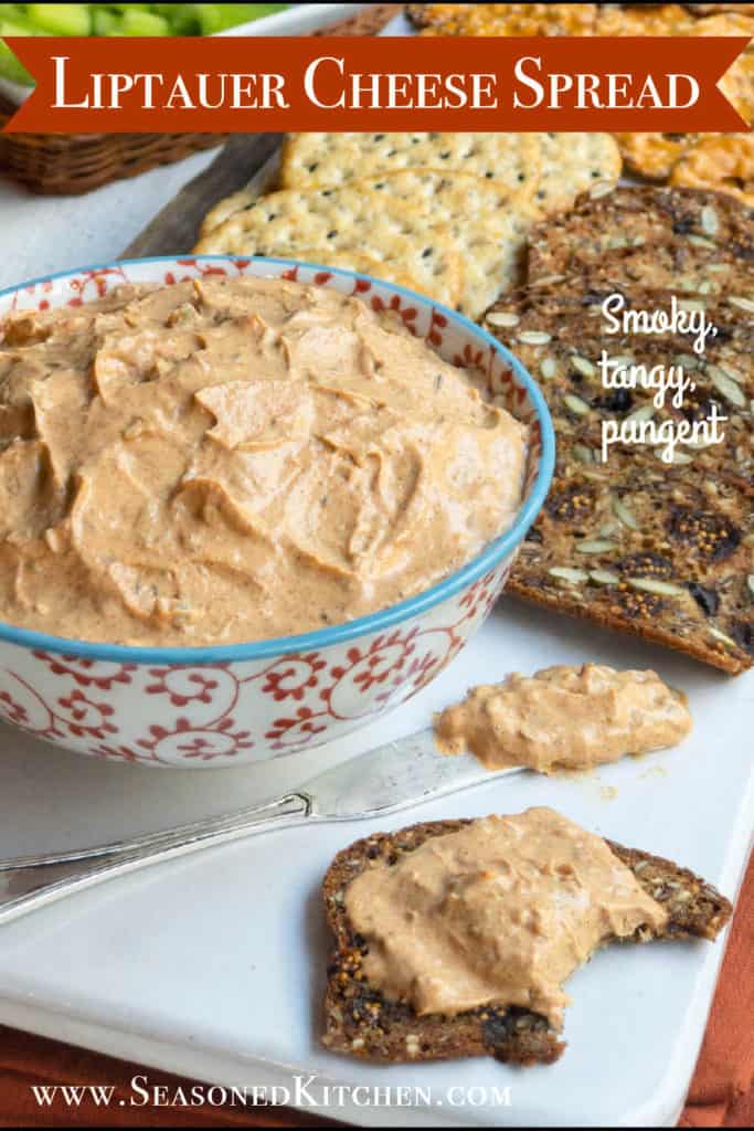 bowl of liptauer cheese surrounded by crackers, formatted for sharing