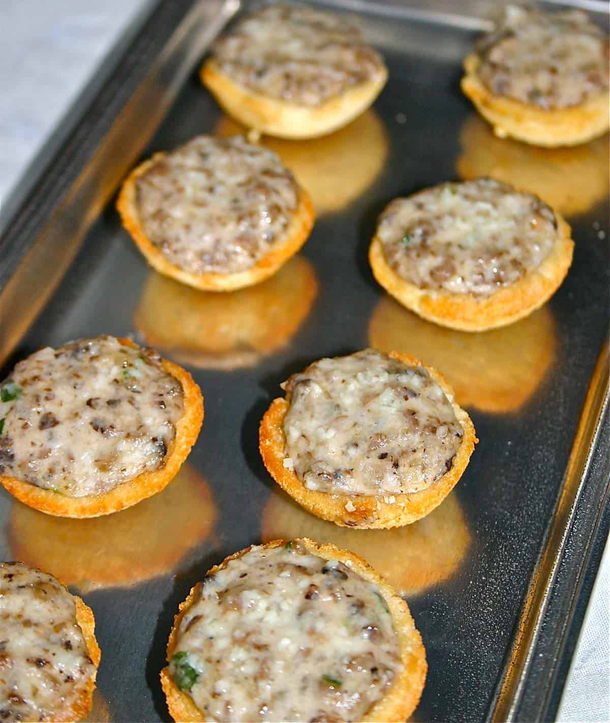 Croustades filled with mushroom mixture sitting on a pewter platter