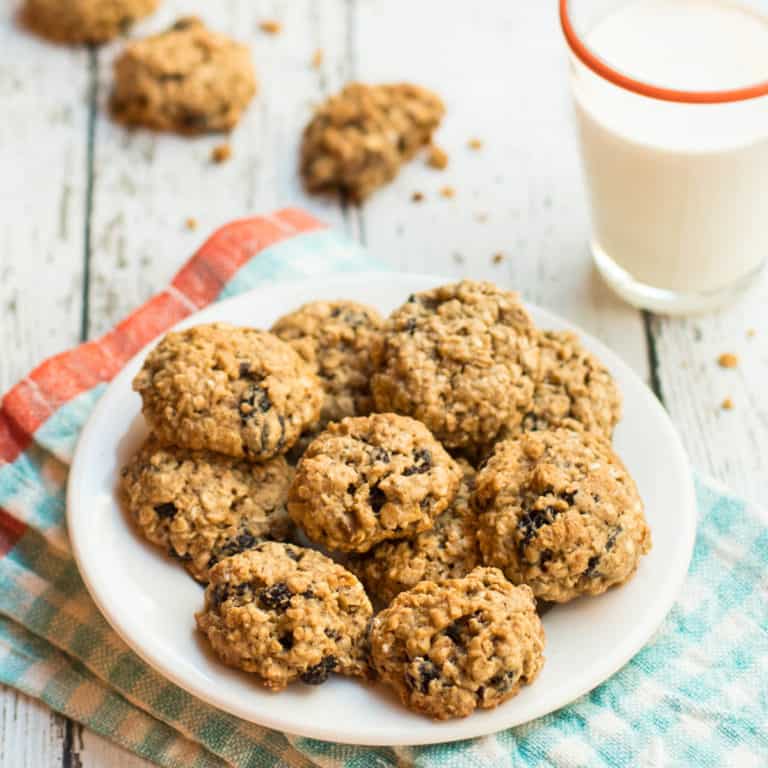 Mini Oatmeal Raisin Cookies on small plate with glass of milk
