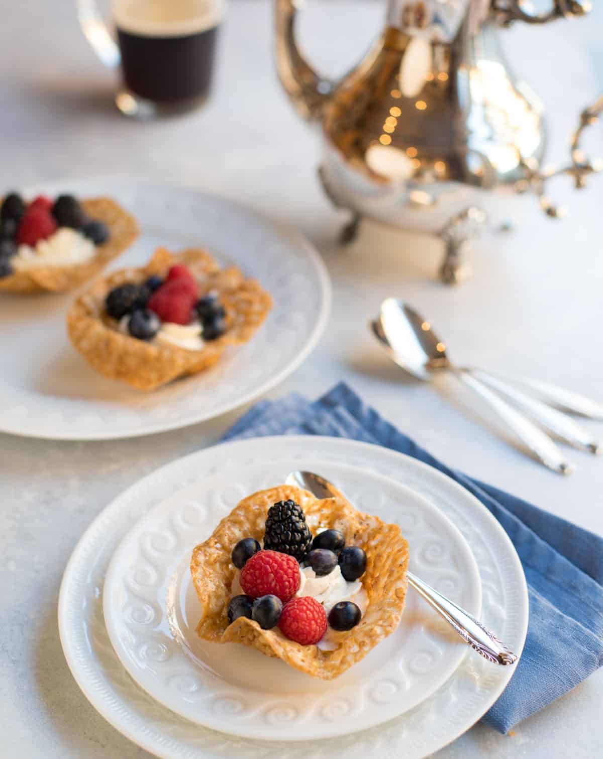 Pecan cookie cups with white chocolate rum mousse and fresh berries with coffee
