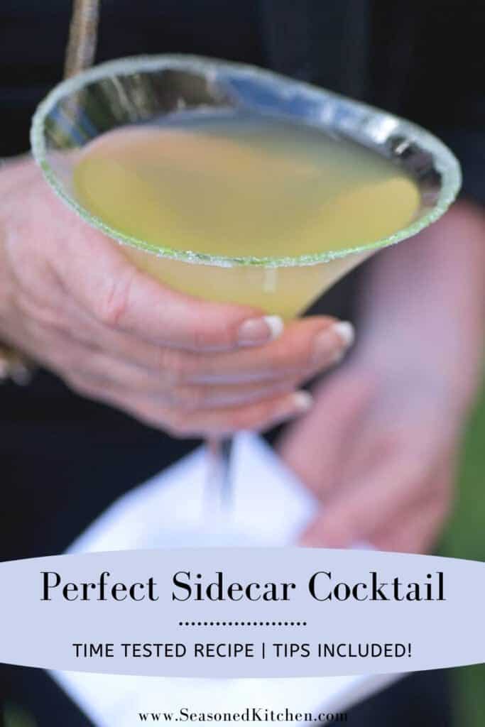 person holding a martini glass filled with a Perfect Sidecar Cocktail