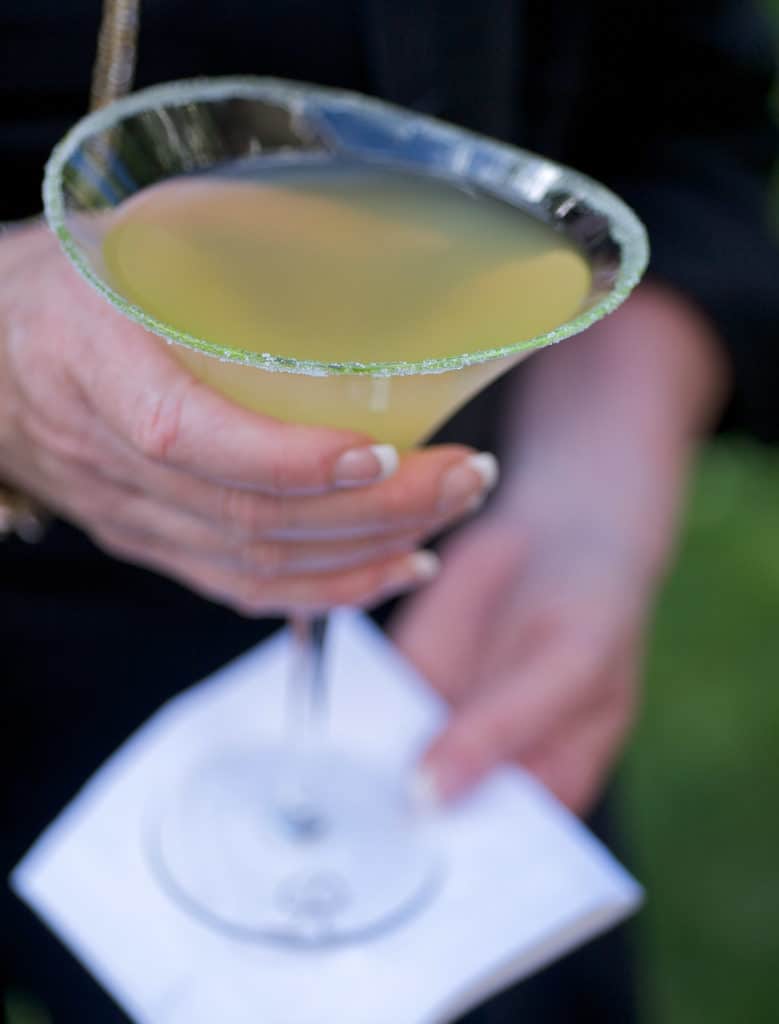 person holding a martini glass filled with a Perfect Sidecar Cocktail