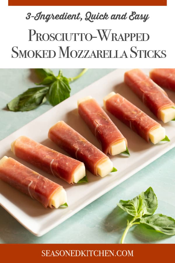 Retangular white platter filled with Prosciutto-Wrapped Smoked Mozzarella Sticks