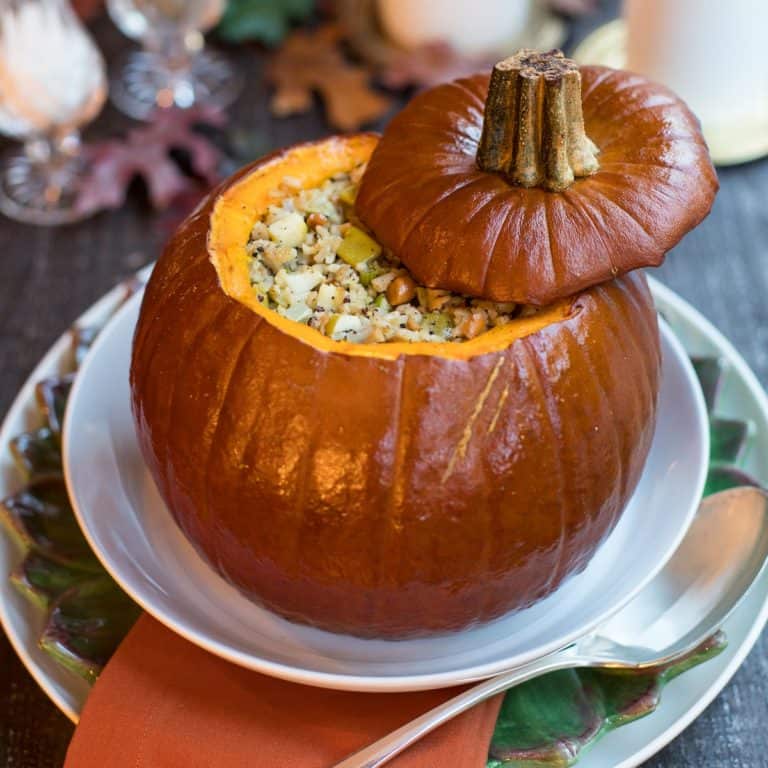 Roasated Pumpkin with Apple Cashew Stuffing on a white platter