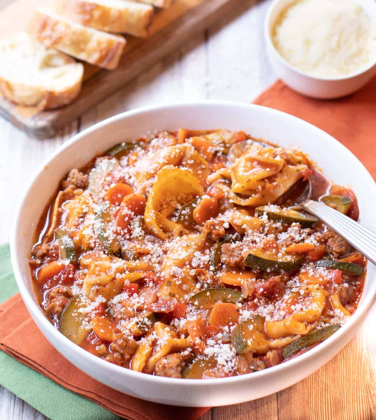 Bowl of soup with tortelloni, sausage, zucchini and carrots