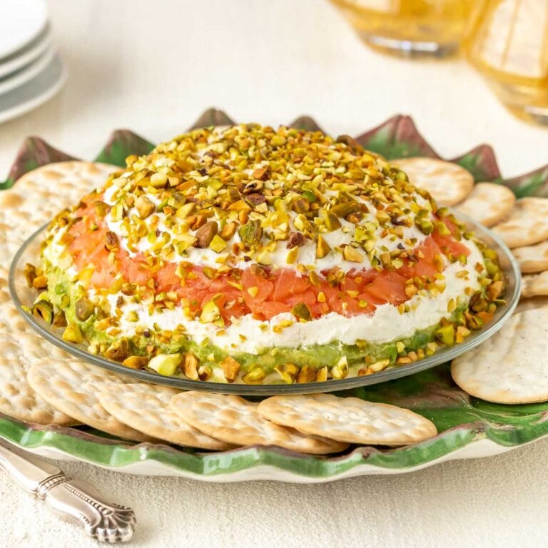 Smoked Salmon Cream Cheese Spread with Avocado on a serving platter surrounded by crackers