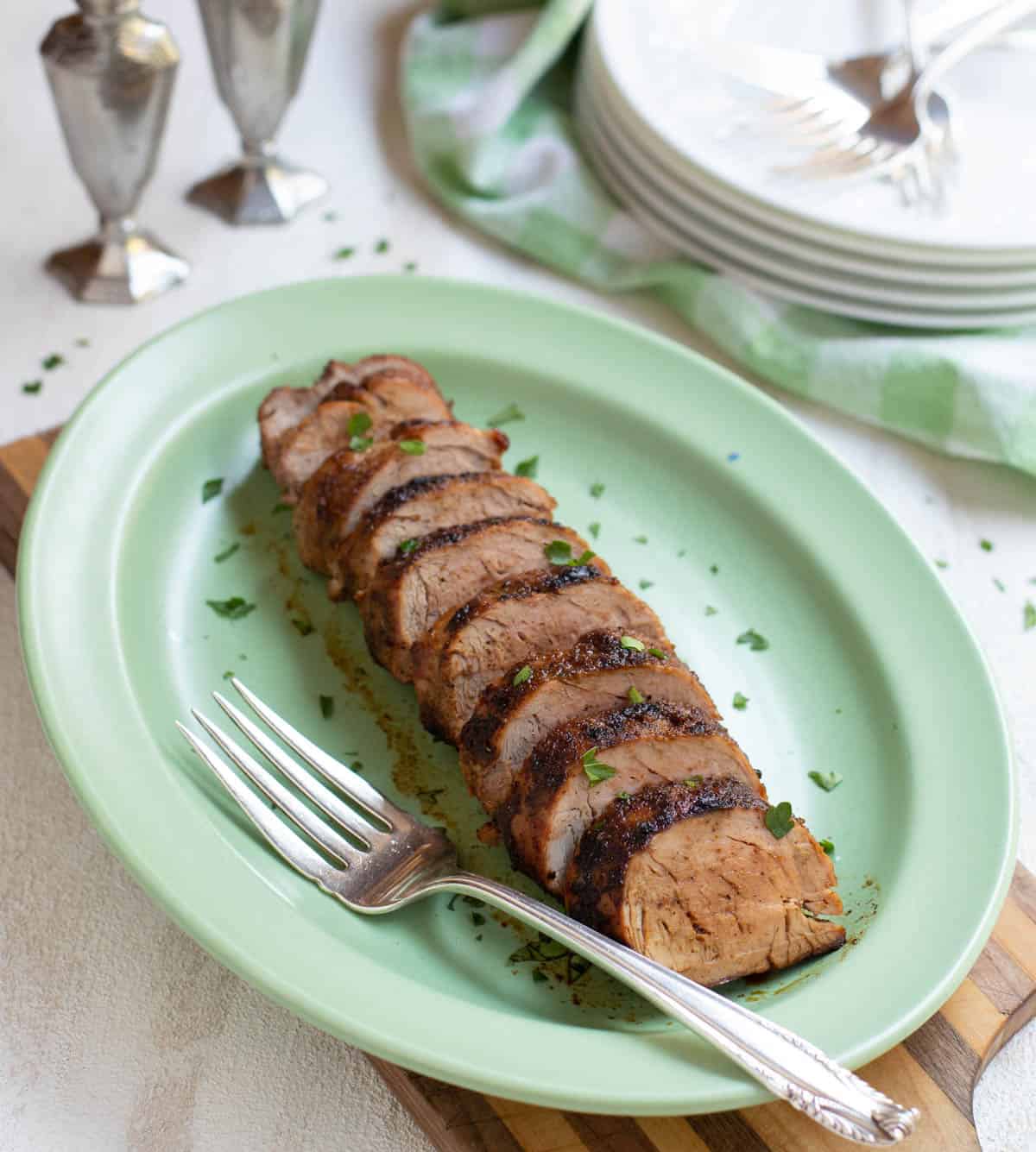 Grilled rubbed pork tenderloin sliced and served on a platter
