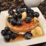 English muffin stuffed with cream cheese and topped with fresh fruit