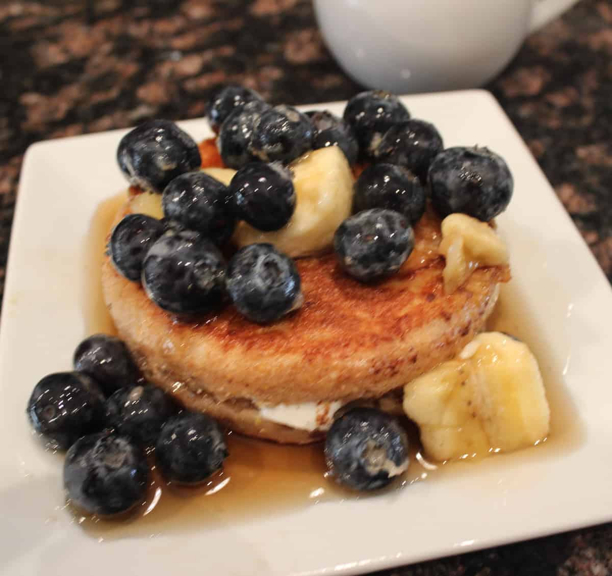 English muffin stuffed with cream cheese and topped with fresh fruit