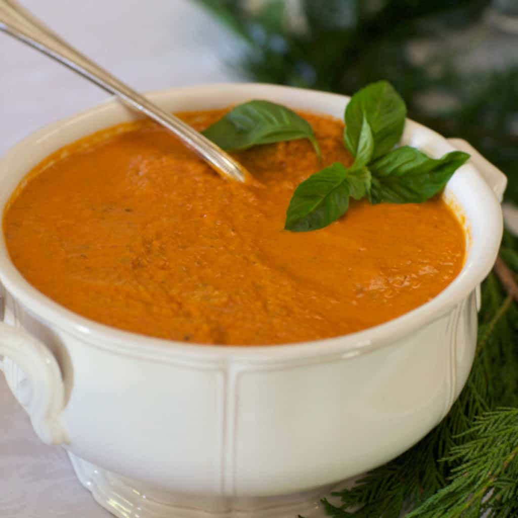 White soup tureen filled with Tomato Basil Bisque