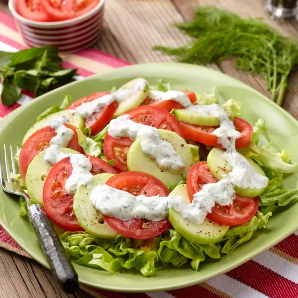 Sliced tomatoes and cucumbers with yogurt-mint dressing