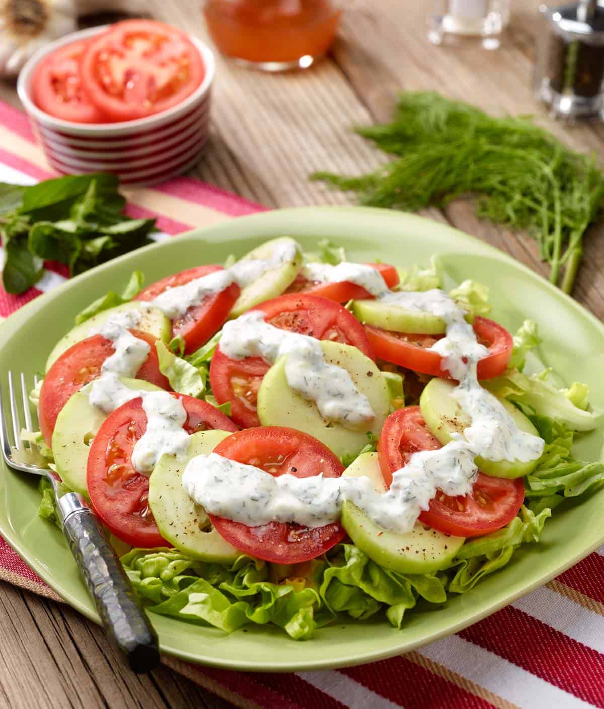 Sliced tomatoes and cucumbers with yogurt-herb dressing