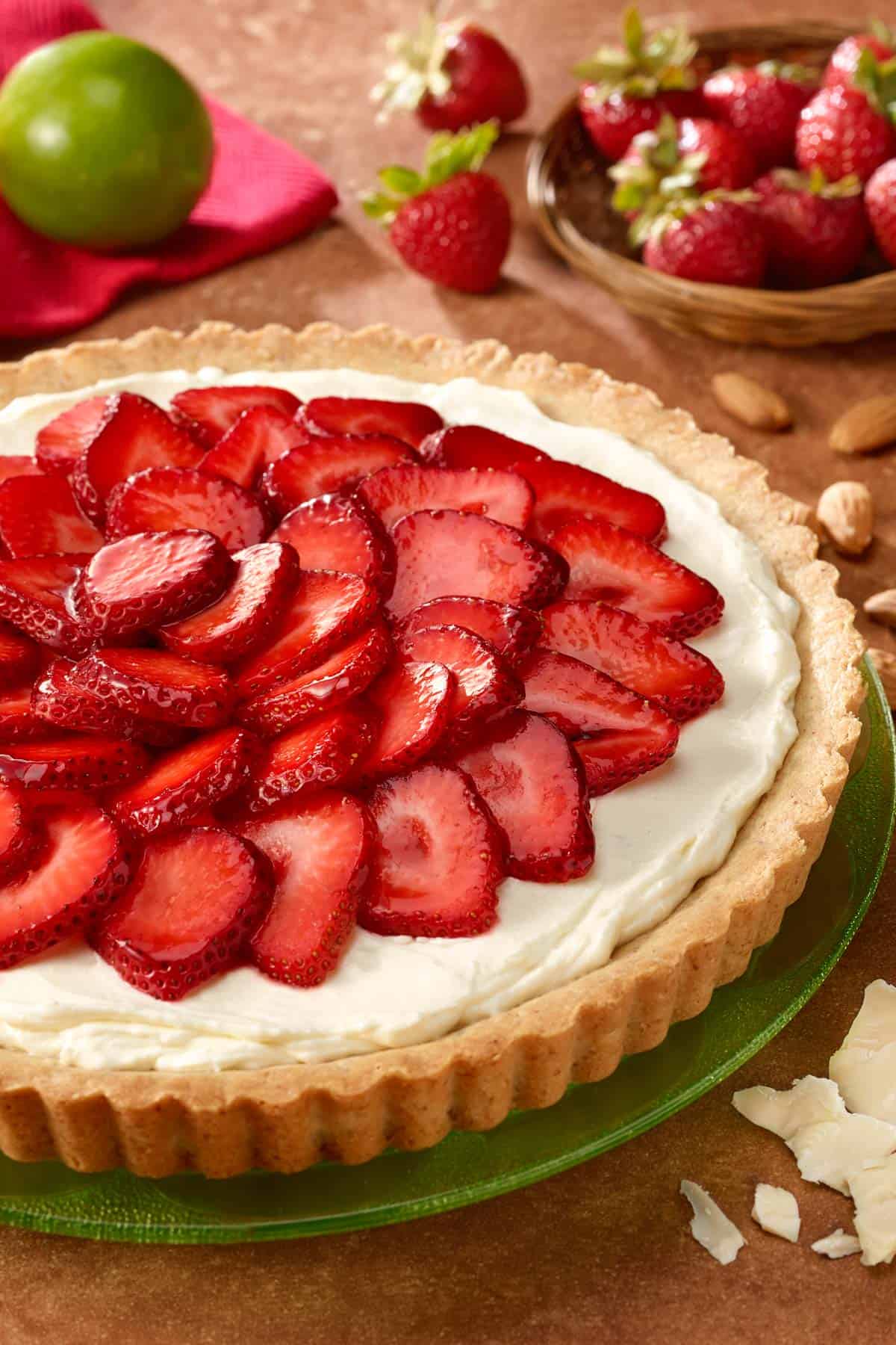 Round green plate with White Chocolate Lime Tart with Strawberries on top