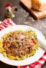 Seasoned ground pork sauce atop zucchini noodles on a plate