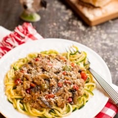 Seasoned ground pork sauce atop zucchini noodles on a plate