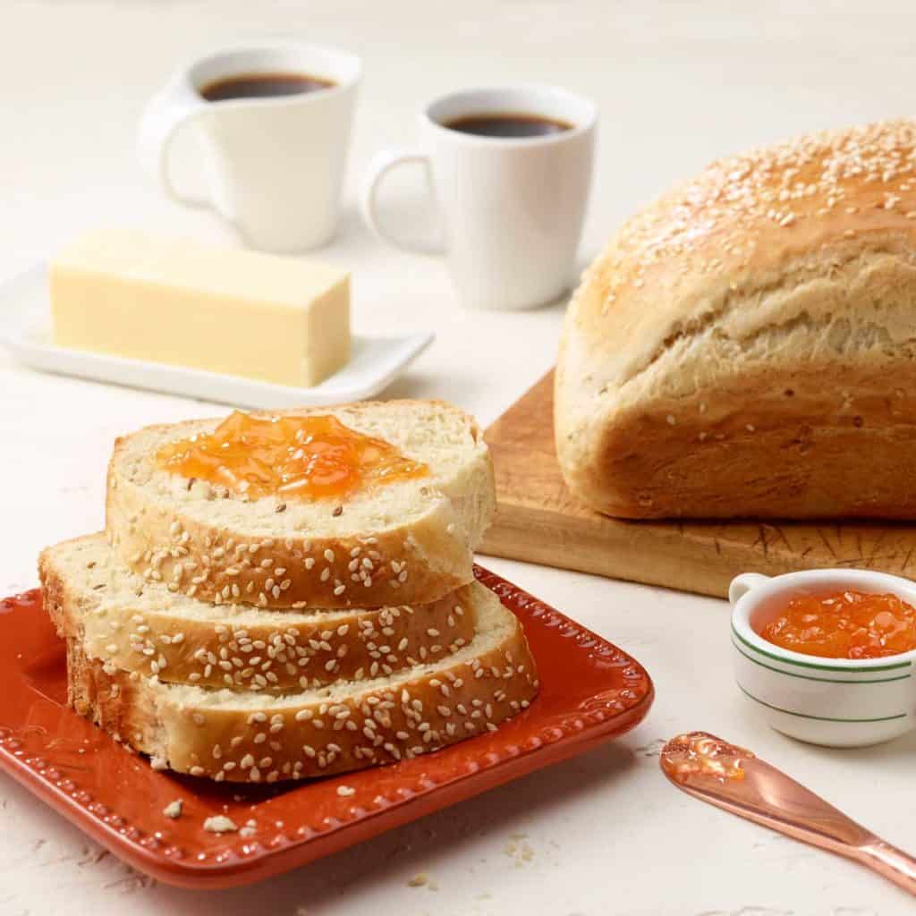 Small square plate showing 3 slices of Anise Bread; loaf to the right.