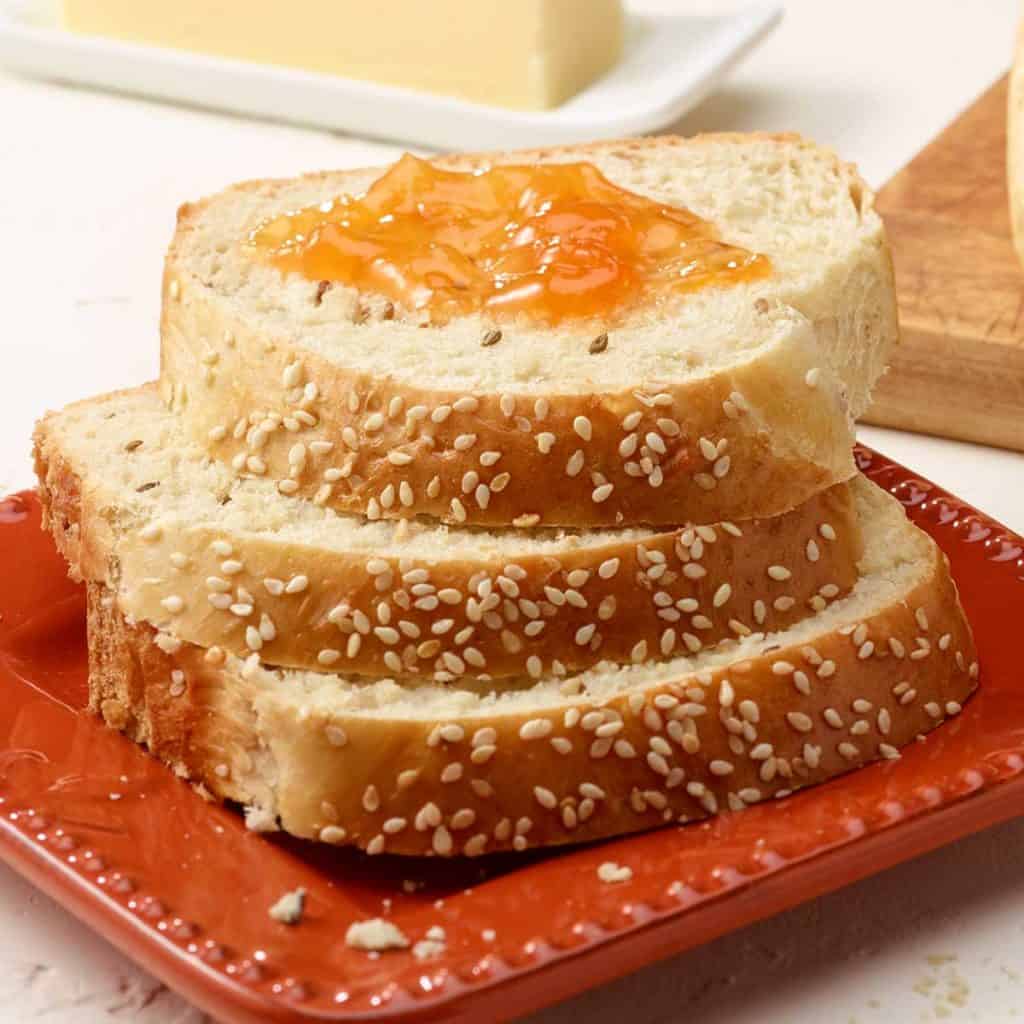 Close up of square red plate showing 3 slices of Anise Bread