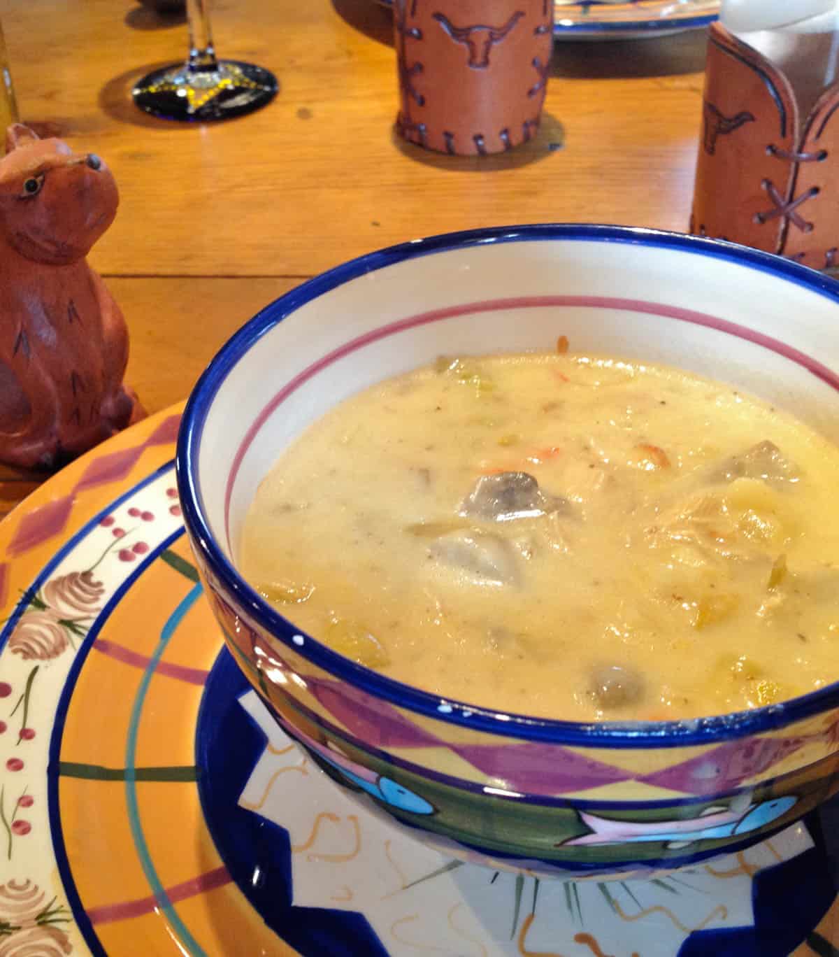 Multicolored bowl filled with Artichoke and Chicken Chowder
