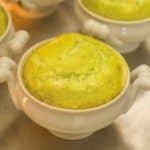 close up of white dish showing individual cooked Asparagus Soufflé