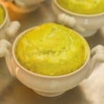 close up of white dish showing individual cooked Asparagus Soufflé