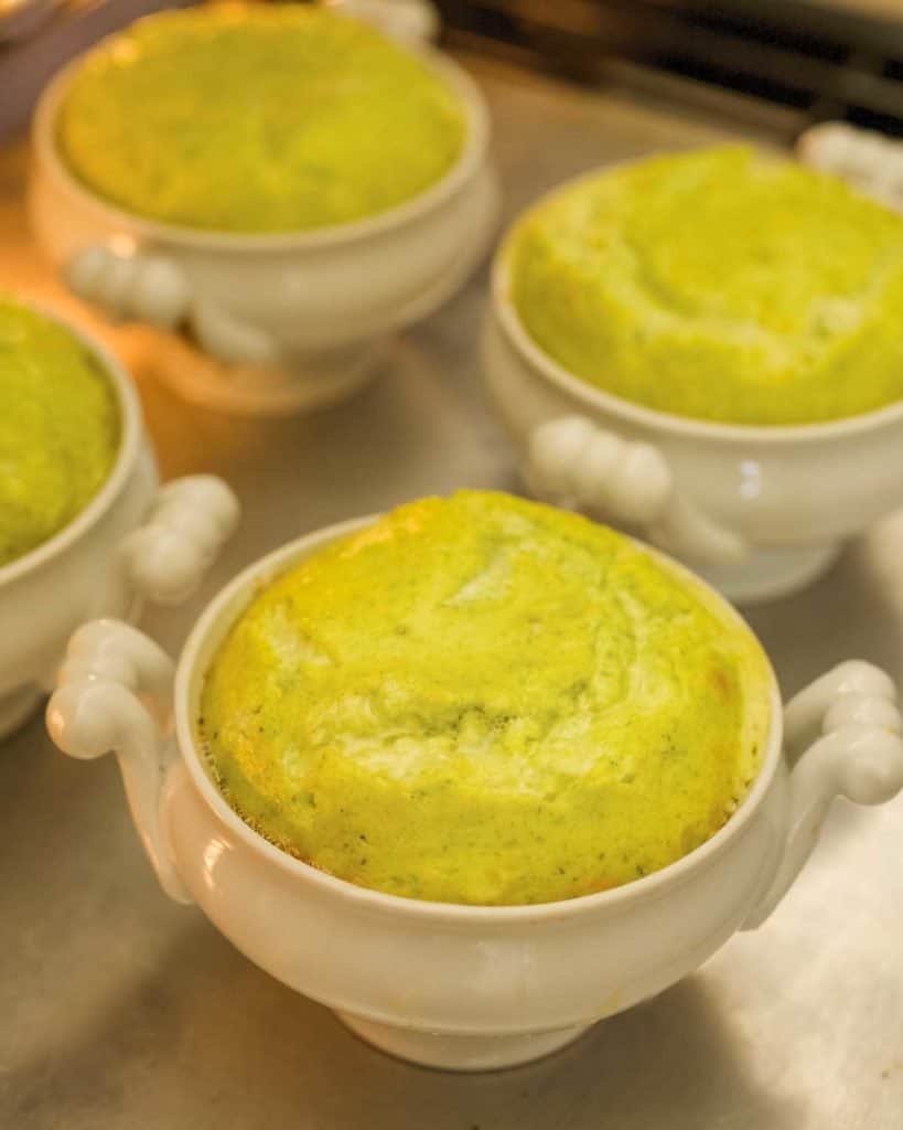 Four white dishes holding cooked Asparagus Soufflé