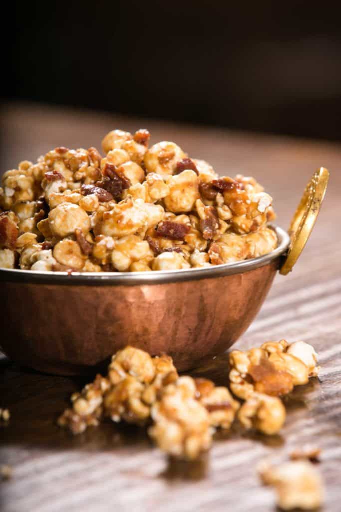 Copper bowl filled with Bacon and Cashew Caramel Corn.