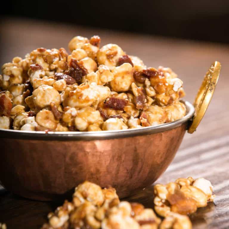 copper bowl filled with Bacon and Cashew Caramel Corn