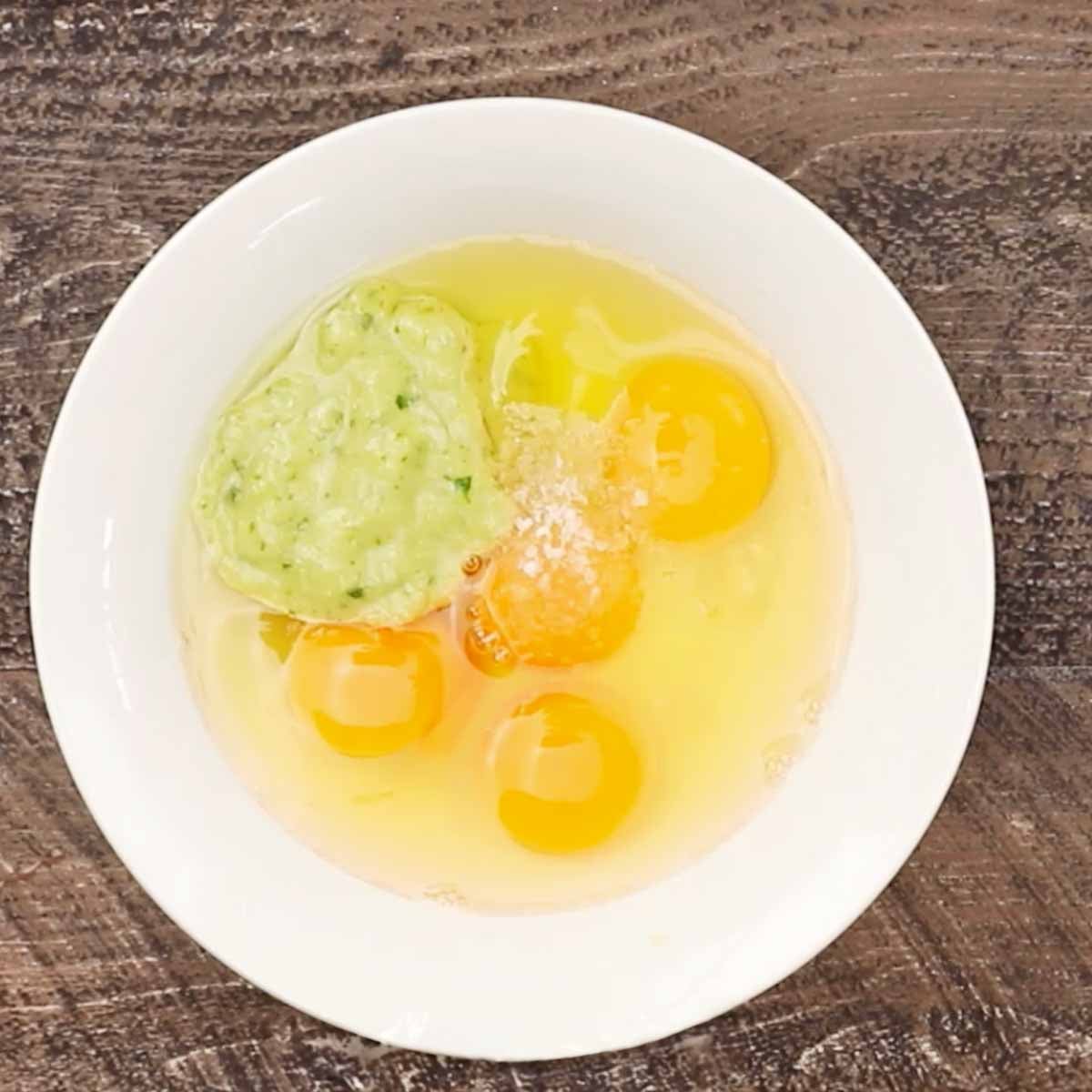 Eggs in a bowl with some salsa verde. 